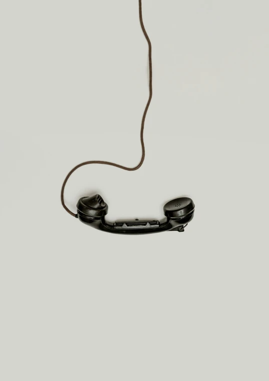 a telephone is shown with the cord wrapped around
