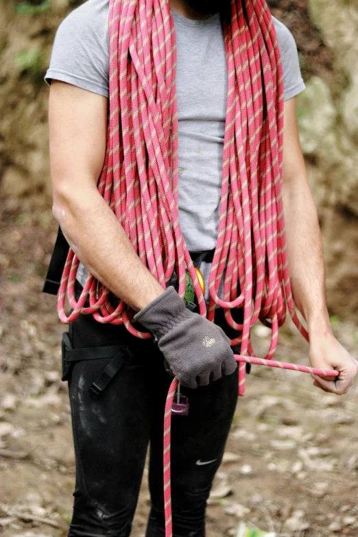 a man wearing a beard and carrying a rope