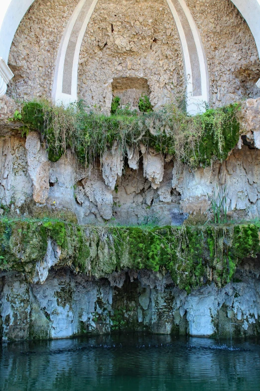 a rock building with ivy growing on it