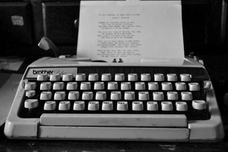 an old typewriter with a paper attached to the keys