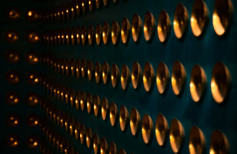 a blue and gold wall with several gold circles on it