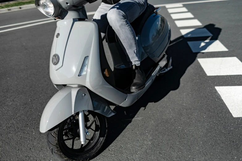 the person riding on a gray motorcycle is looking straight ahead