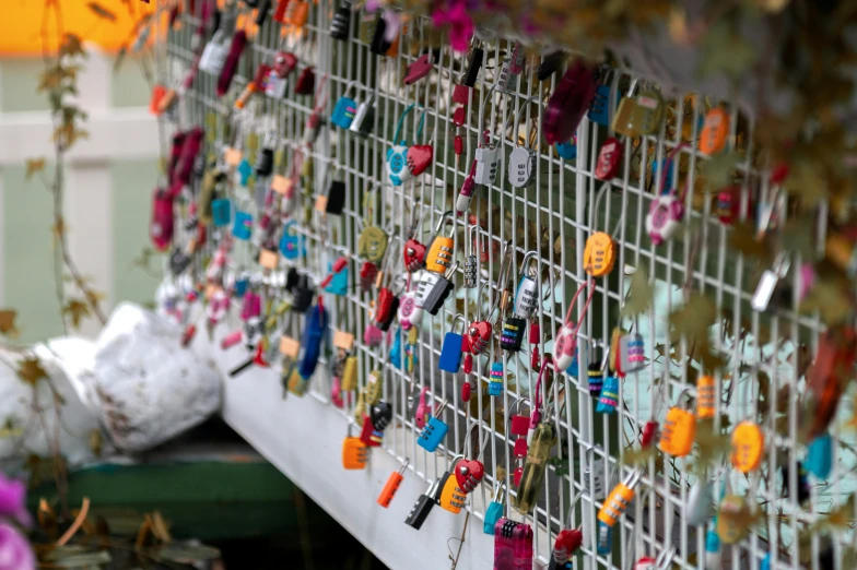 an artistic display with small heart shaped items hanging on a wall