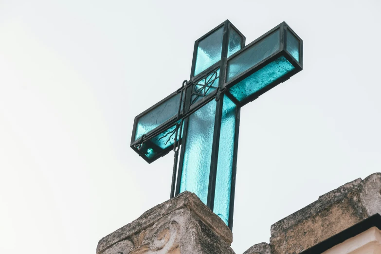 the cross has a blue glass design in it