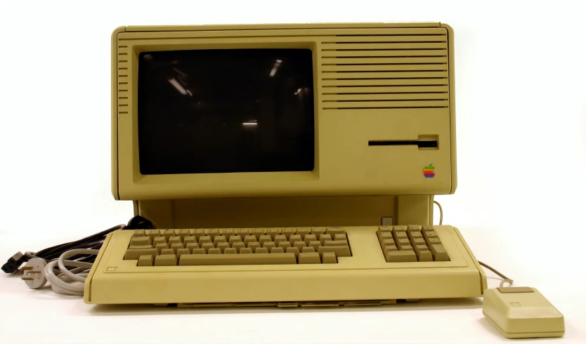 an apple desktop computer has been placed next to a floppy