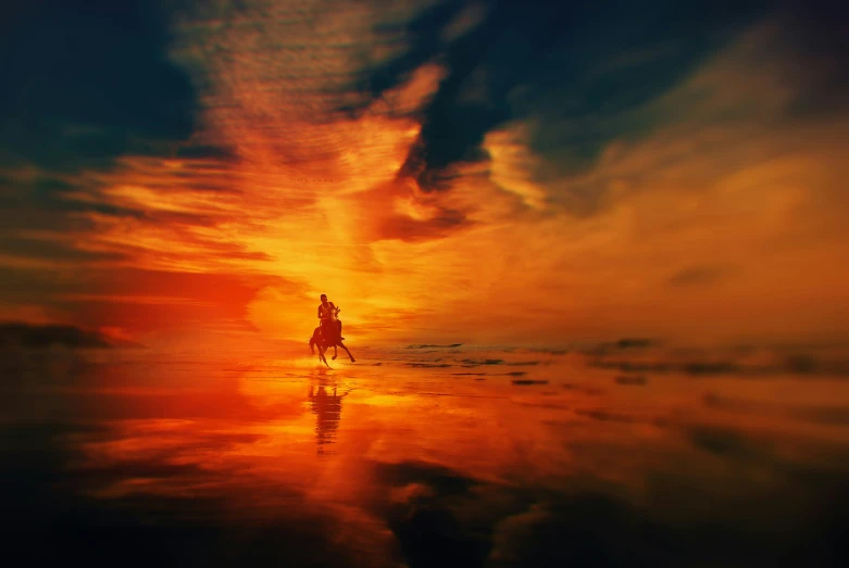 a person riding on the back of a horse through a sea at sunset