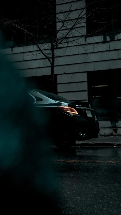 a car in the street in front of a building