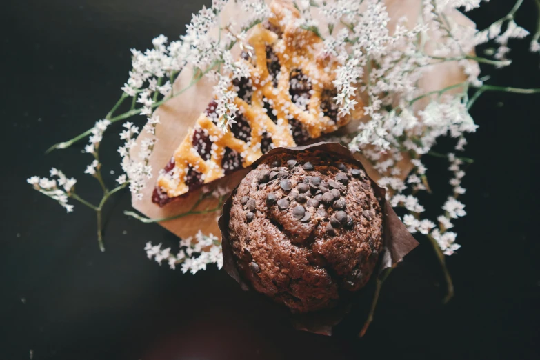 desserts are displayed with flowers on the table