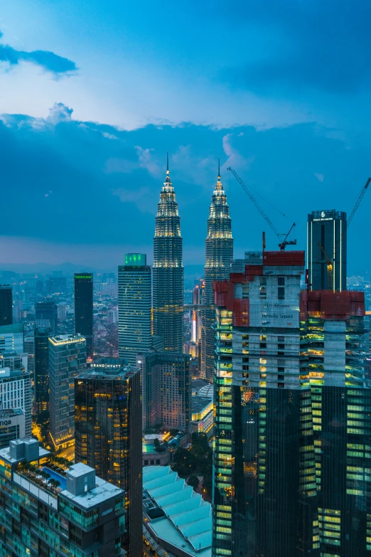 many skyscrs at night with city lights glowing in the background