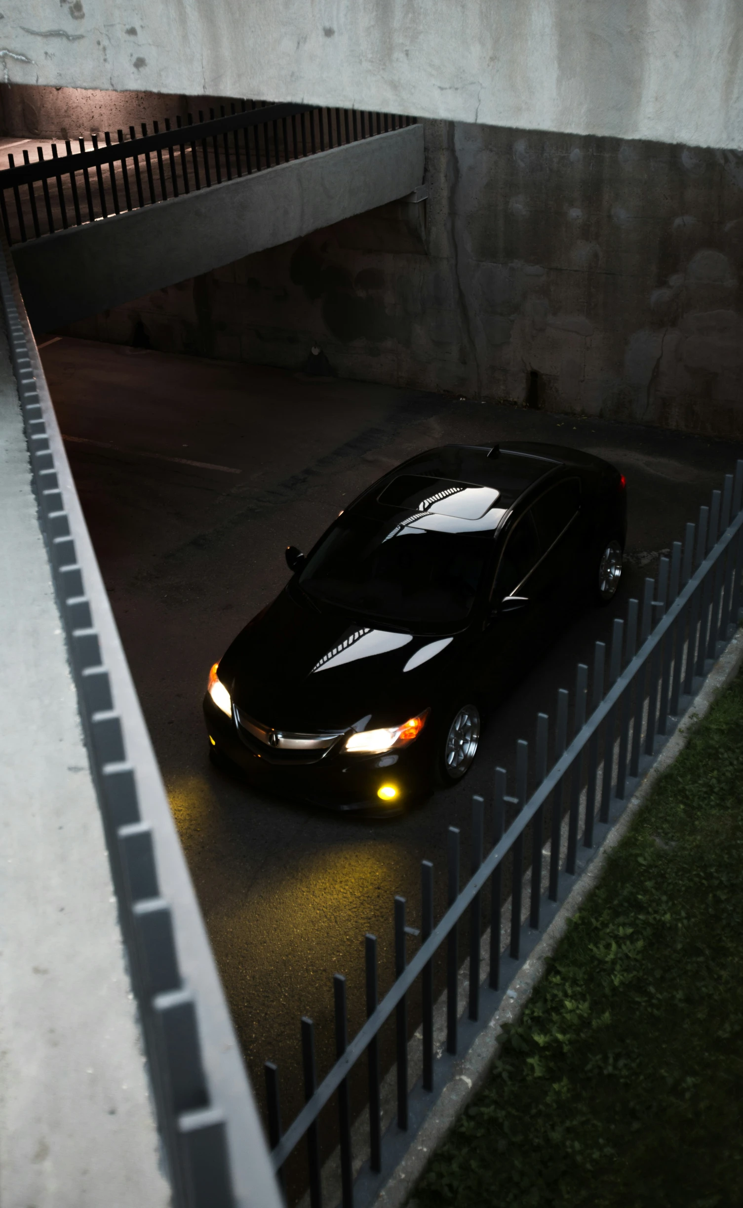 a black car parked in an empty parking lot