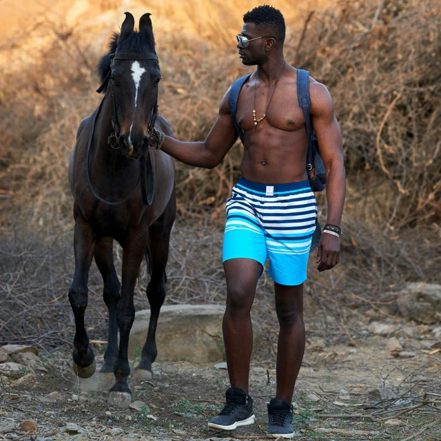 there is a young man that is walking his horse