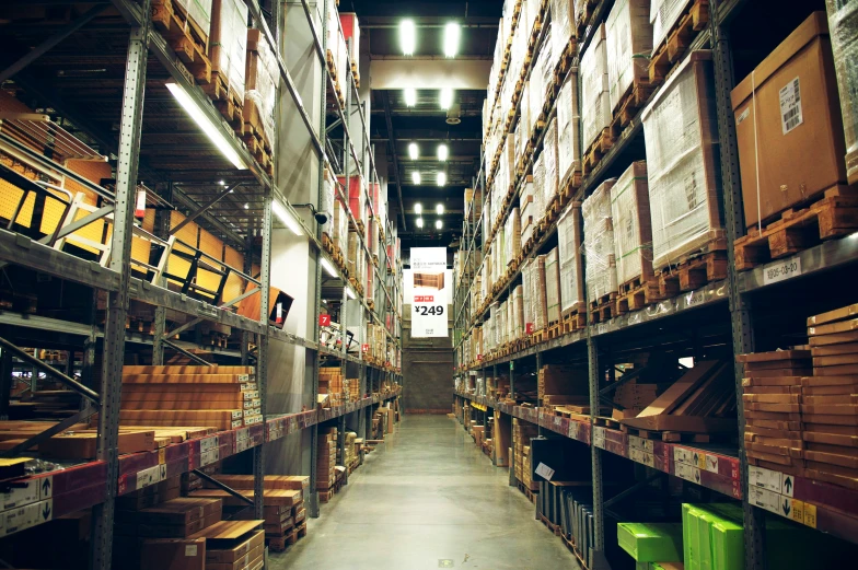 a very wide looking warehouse full of pallets