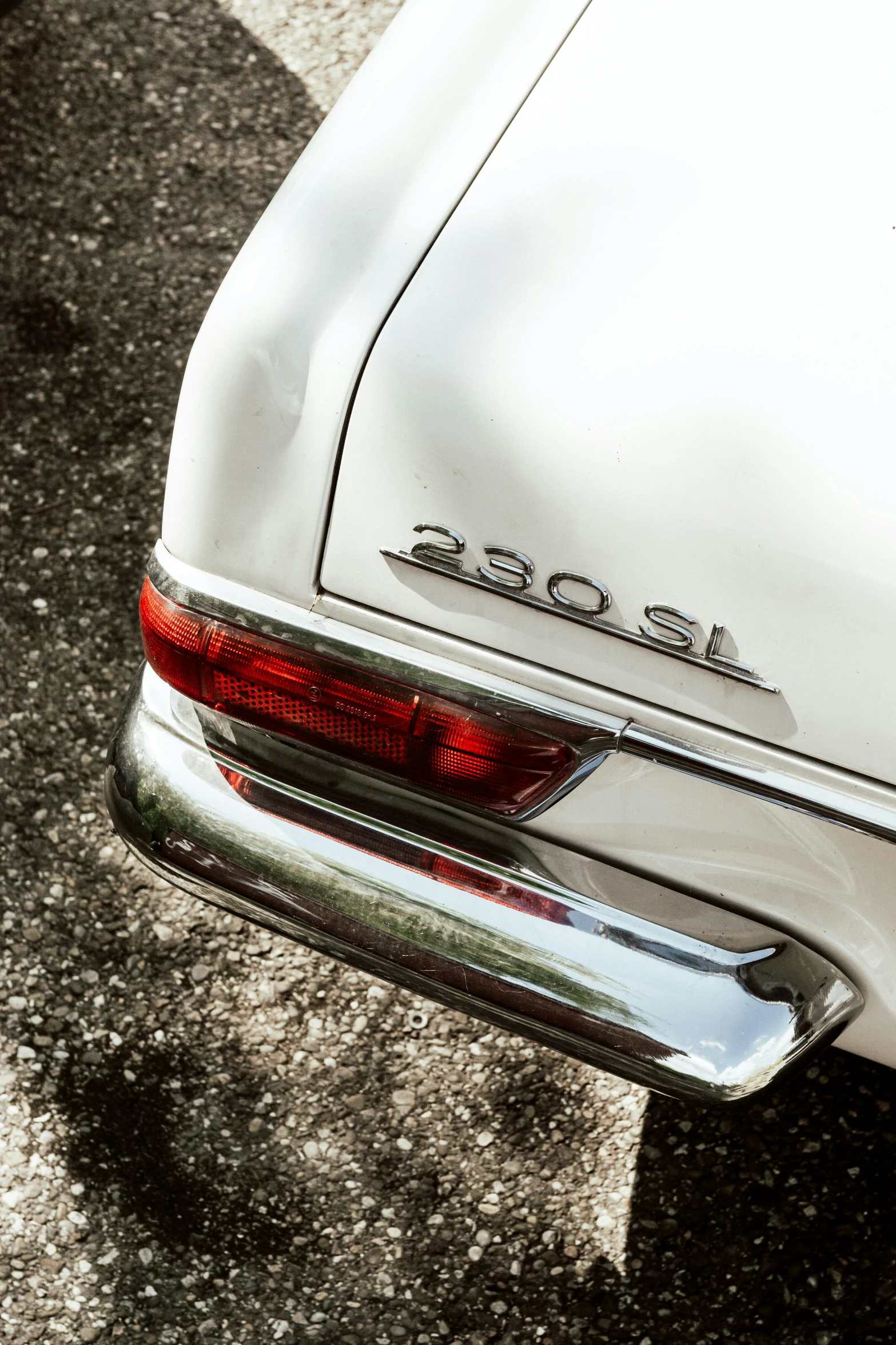 the back end of a white vintage car