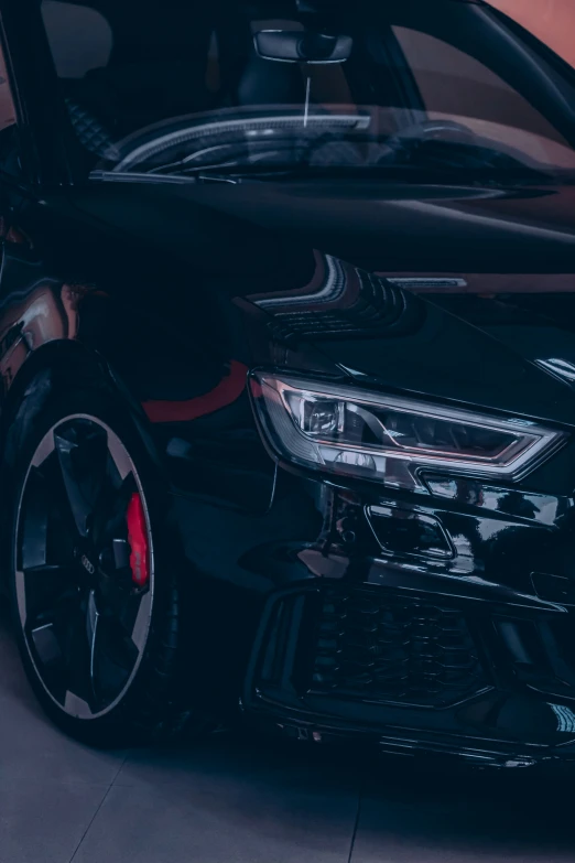 the front end of a black car in a garage