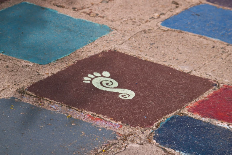 colorful tiles with a picture of a small cat and a hand painted paw