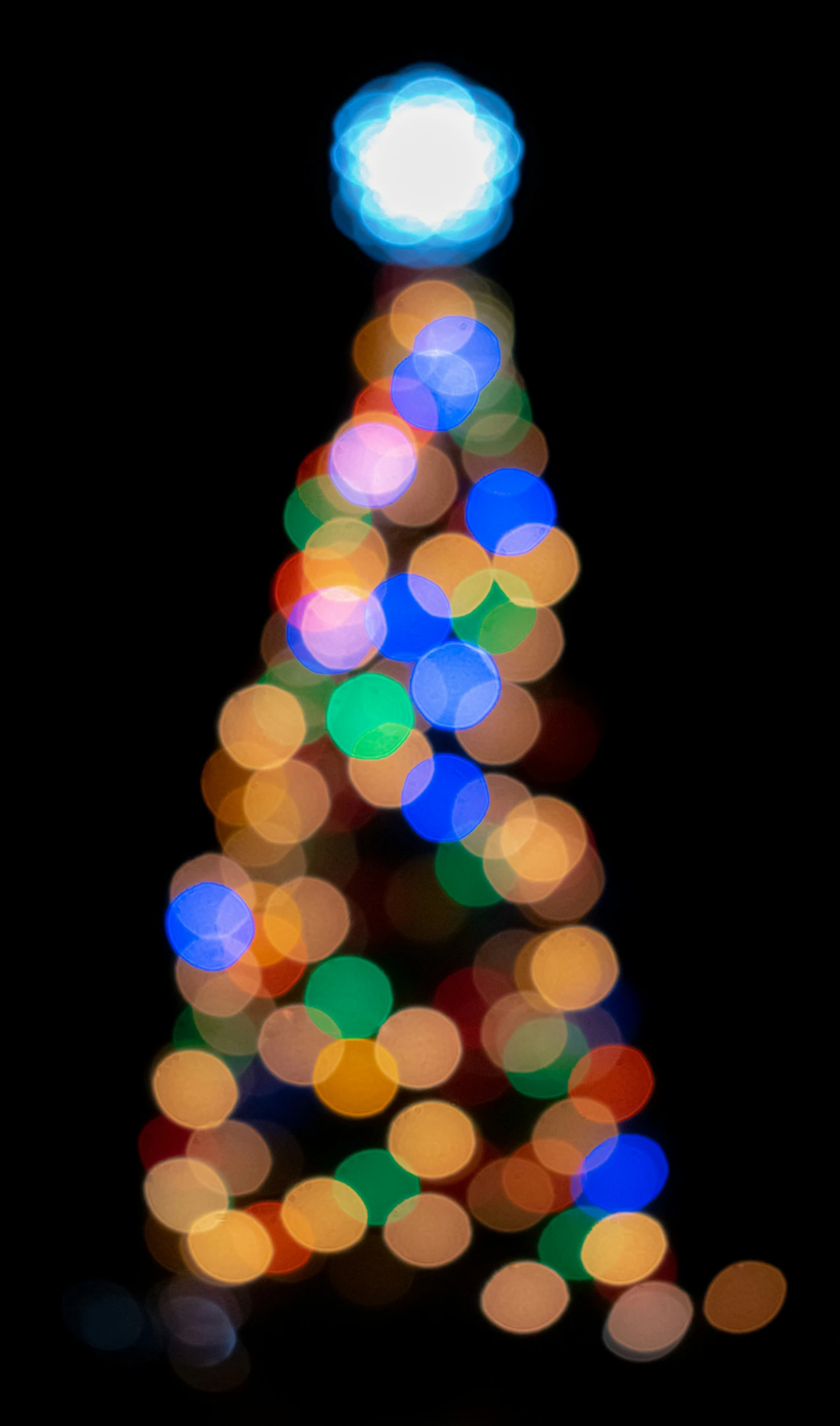 a very big colorful christmas tree with lights