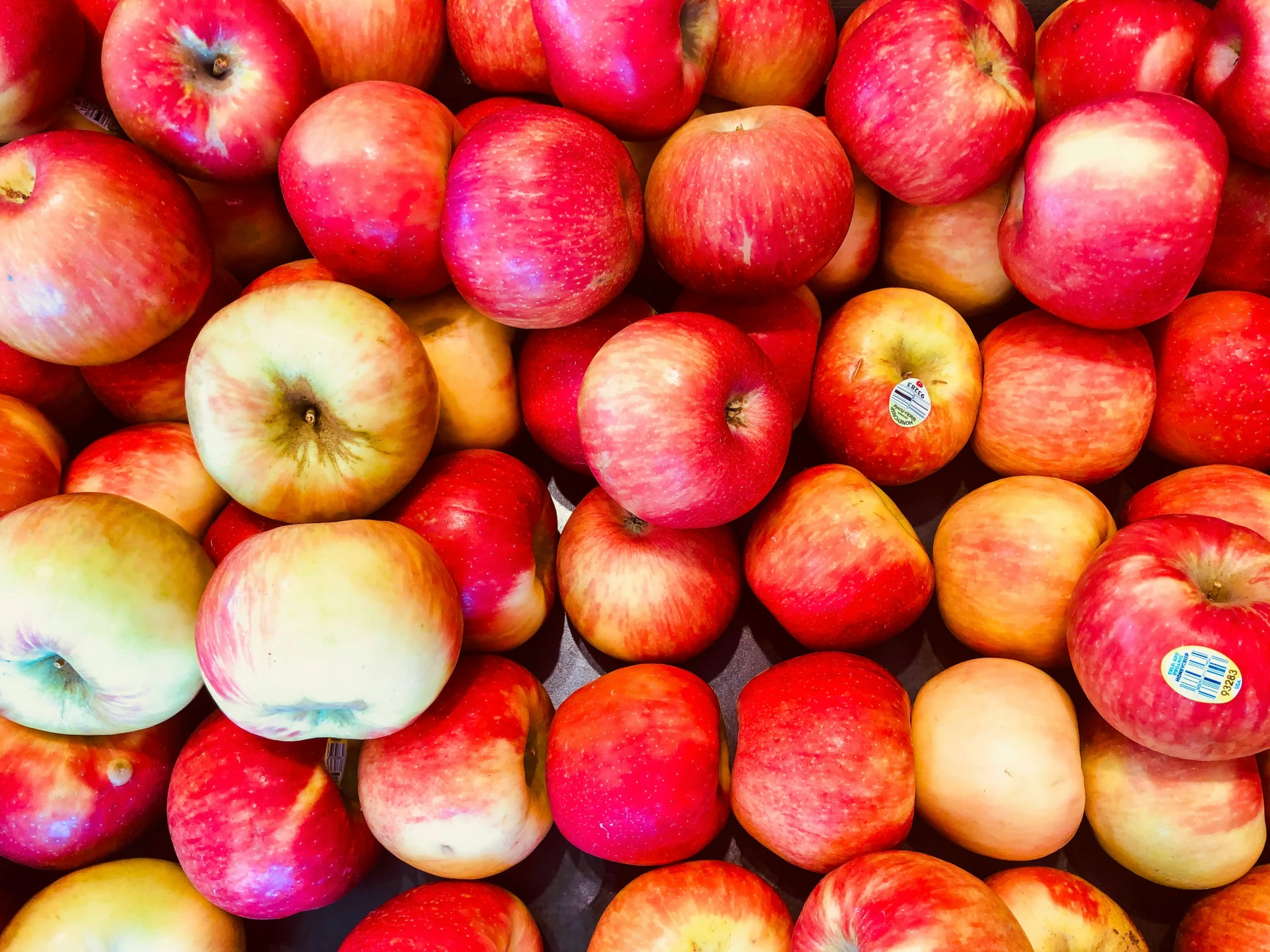 a pile of fresh apples on display for sale