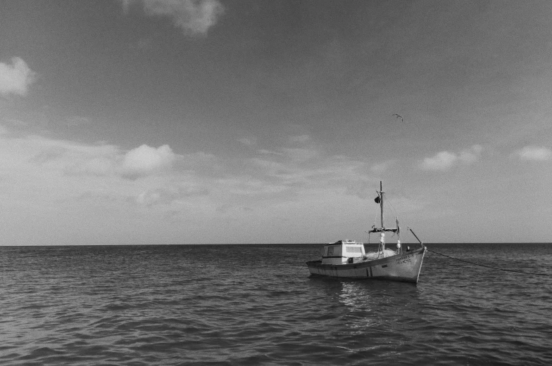 a small boat traveling along the ocean in the sky