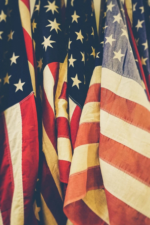 a group of flags are arranged together on the floor