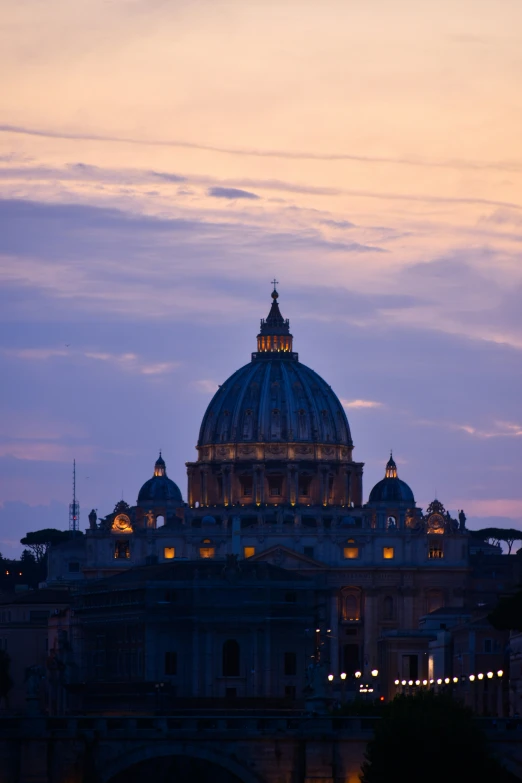 the dome of a large church glows as dusk approaches