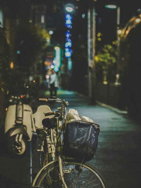 a bicycle with a basket parked next to a bicycle rack