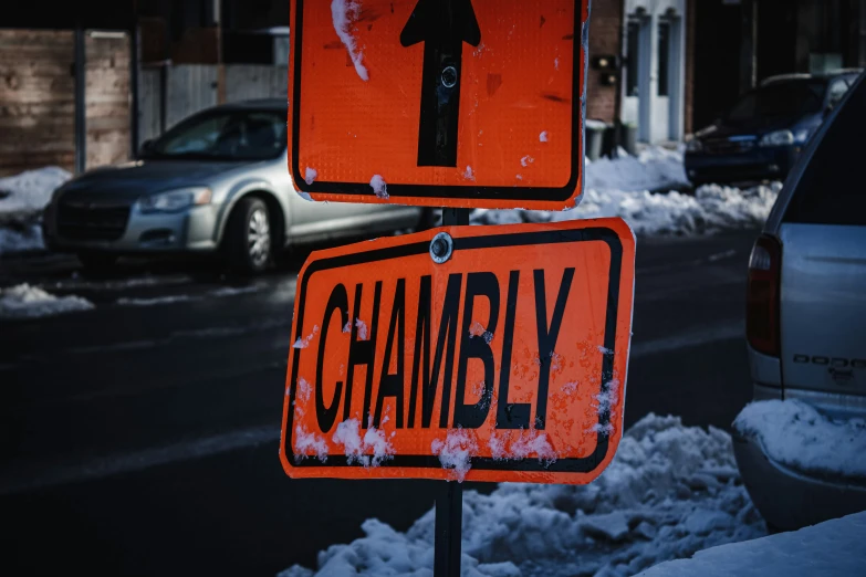 two street signs that read cambly and a one way sign