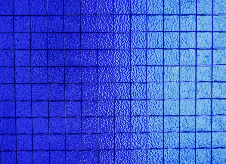 a blue tile wall in the bathroom is very textured