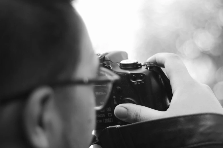 a man taking a picture while holding a camera