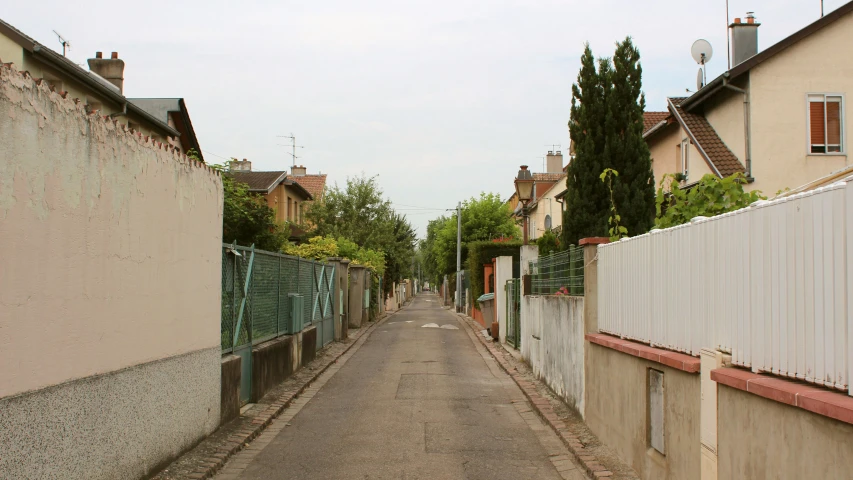 a long paved road leads into a neighborhood