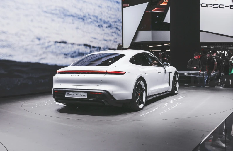 a porsche car is displayed in a showroom