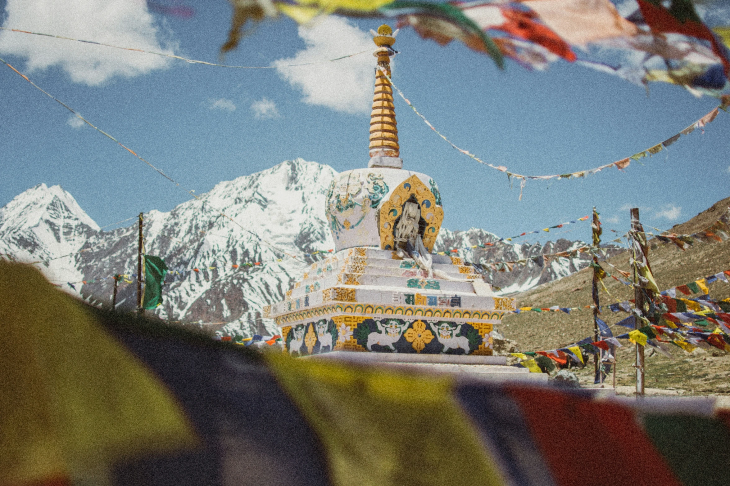 a mountain view of a colorful pagoda in the middle of tibet