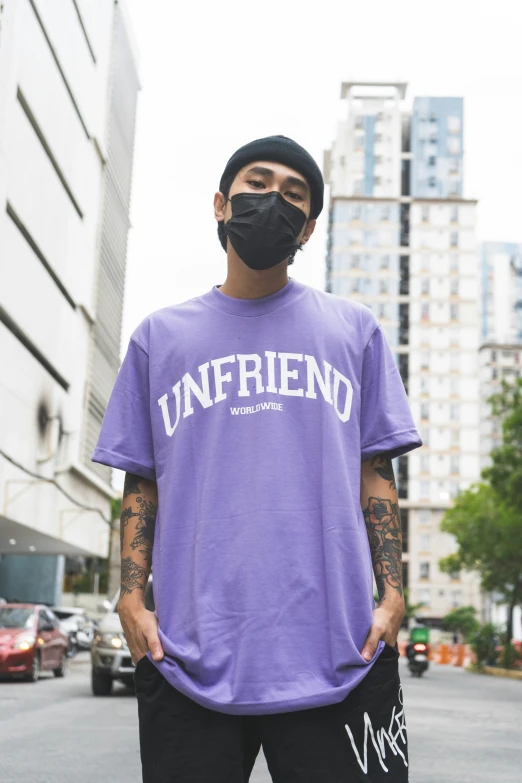 a man with a bandana stands on a street