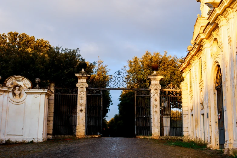 an entrance gate with carved carvings next to stone buildings