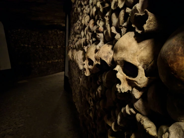 a wall that has many skulls piled on it