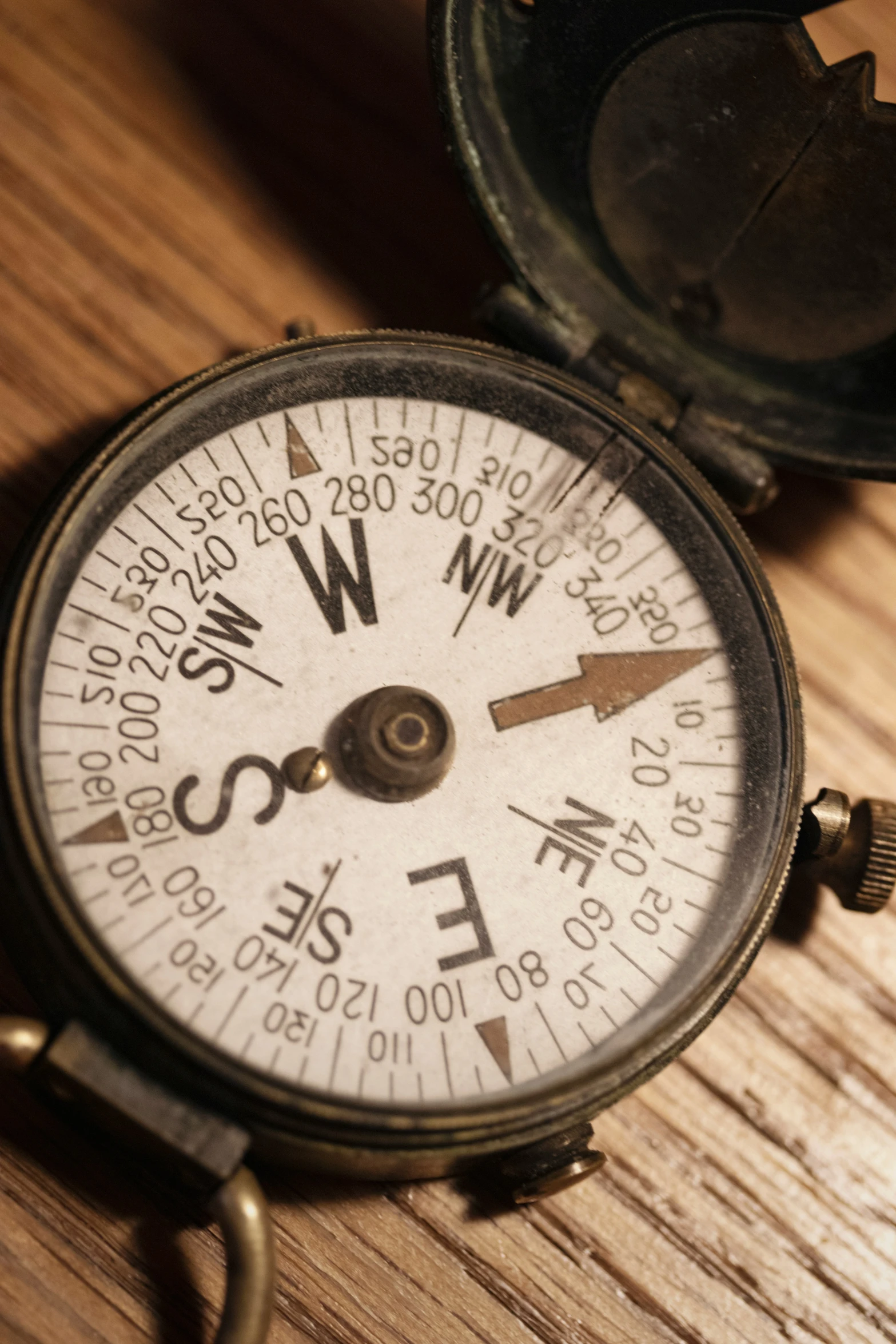 an old compass on a table with an open case