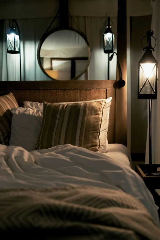 an elegant bed with white and brown pillows