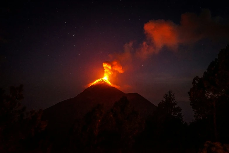 a small fire blazing up into the night sky