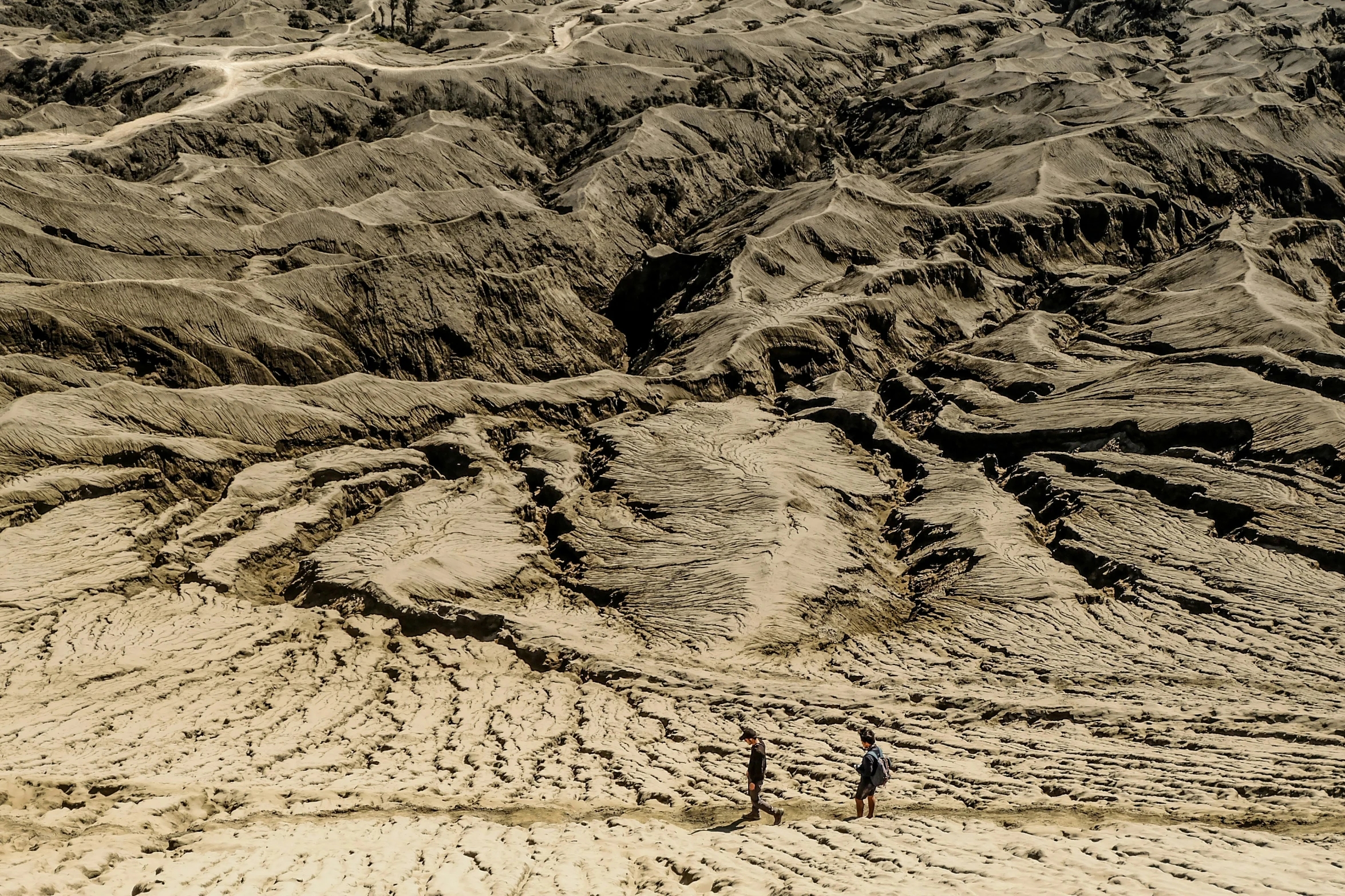 an overhead view of an empty valley with a mountain in the background