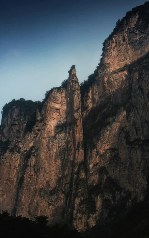 two mountains and one is in the background with blue sky