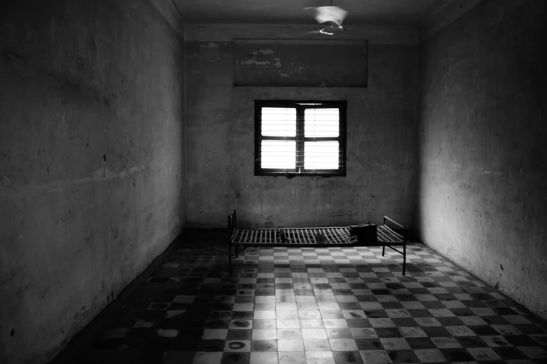 a room with a bench and light shining through the window