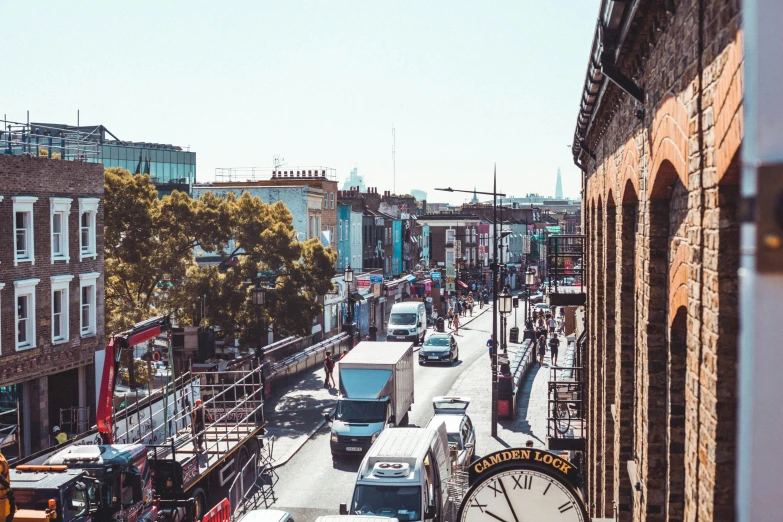 cars driving down an old street with traffic passing by