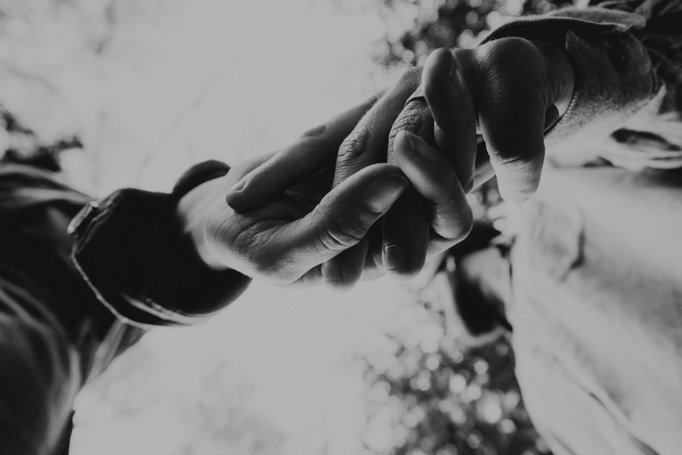 two hands holding each other and one being taken with a camera