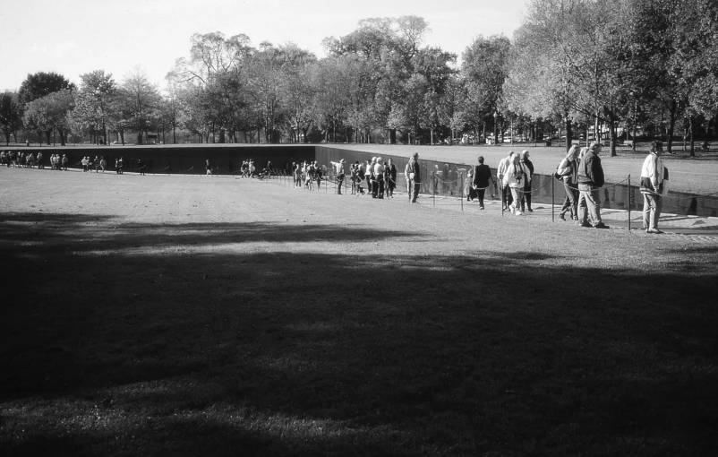 a large group of people standing in a park