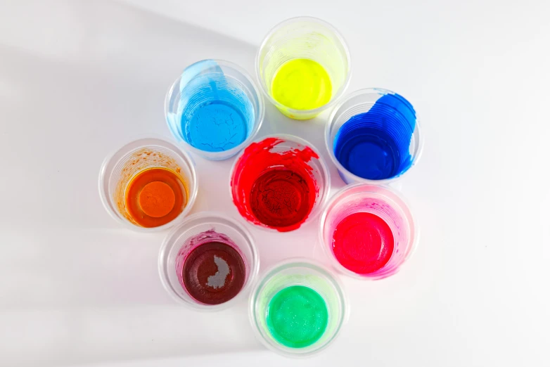 seven colorful plastic containers with lots of different colors