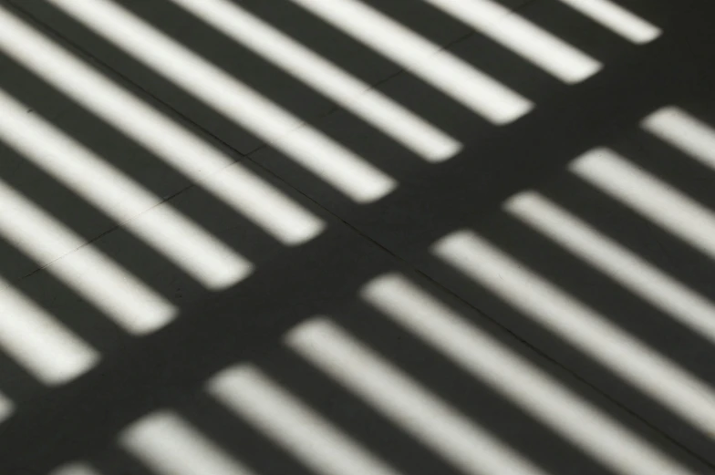 the shadows of a wall cast onto a bench