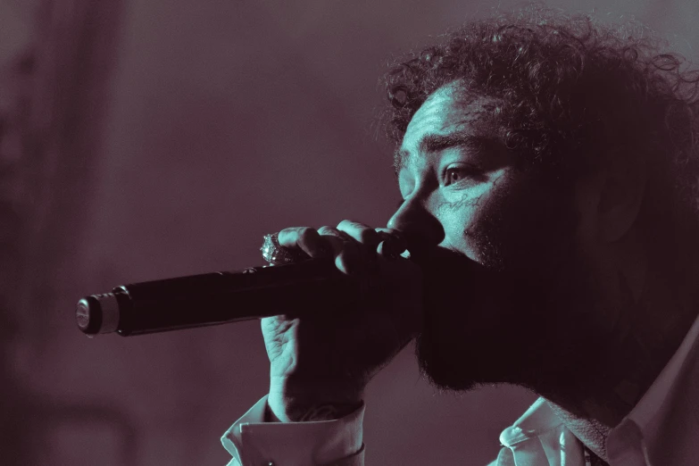 man singing with a microphone in a black and white po