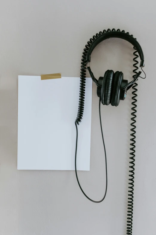 a pair of headphones connected to a white piece of paper