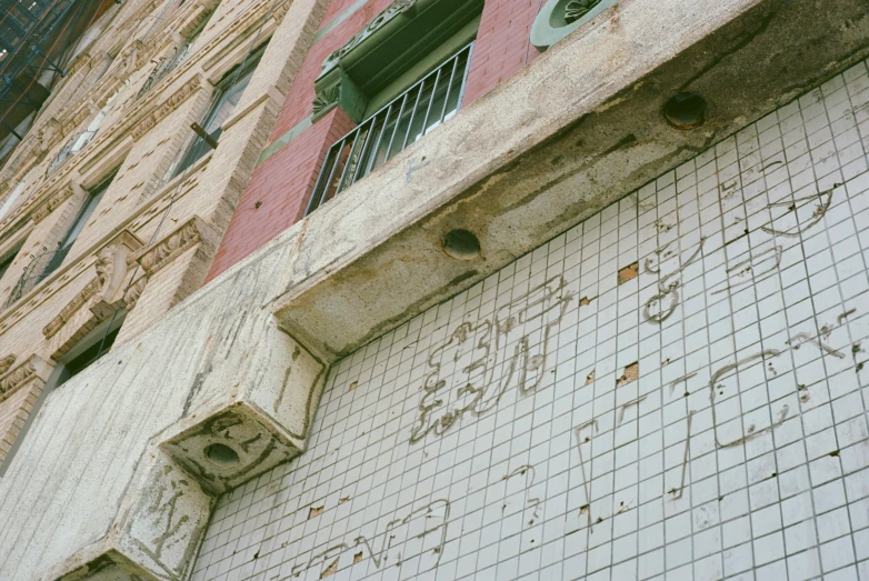 a building wall with graffiti writing on it