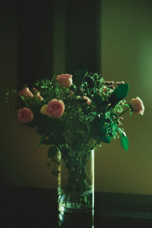 a glass vase containing flowers on a table