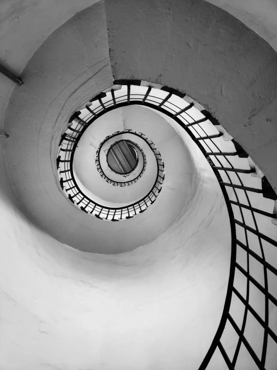 a black and white po of an empty spiral staircase